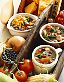 Three Mugs of Hearty Vegetable and Black Bean Soup with Fresh Soup Ingredients