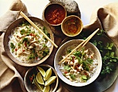 Overhead of Two Bowls of Spicy Asian Chicken Soup with Chopsticks