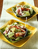 Two Plates of Caesar Salad with Tomatoes; Forks
