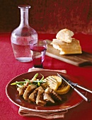 Serving of Sliced Grilled Pork with Grilled Polenta Slices and Green Beans; Glass of Water