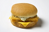 A Fried Fish Sandwich with Tartar Sauce and Cheese