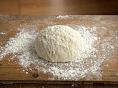 Kneaded Dough on Wooden Board with Flour