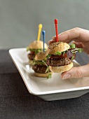 Hand holding a mini-hamburger