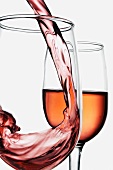 Blush Wine Pouring into Wine Glass; Half Full Glass of Wine