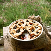 A Blueberry Nectarine Pie on a Window Sill with Slice Removed