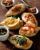 Several chicken breasts with different toppings
