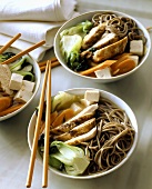 Asian soup with chicken, tofu, pak choi and noodles