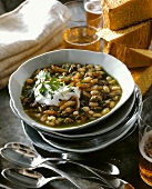Bean stew with sausage, sour cream and coriander