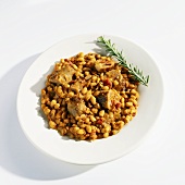 Sausage, Baked Beans and Salsa in a White Bowl with Rosemary Garnish