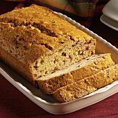 Partially Sliced Cranberry Nut Bread in Rectangular Dish