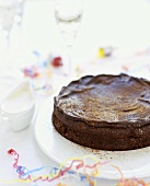 Chocolate Fudge Cake on a Cake Plate with Party Decorations