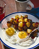 Two Eggs Sunny Side Up with Hash Brown Potatoes on a Plate with a Fork; Cup of Juice and Coffee