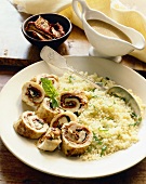 Sliced Chicken Rolled with Sun Dried Tomatoes and Spinach Served with Couscous; Spoon