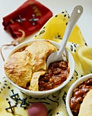 Individual Chili Pot Pies with Cornbread Crust; One with Spoon