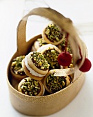 Cream Filled Sandwich Cookies Topped with Pistachios in a Basket