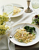 Place Setting of Fettuccini with Broccoli and a Side Salad on a Set Table