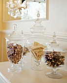 Sweets in glass containers on chest of drawers