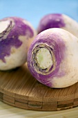 Three turnips on chopping board