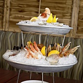 Seafood with lemon wedges, dips and ice on tiered stand
