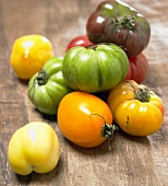 Assorted Heirloom tomatoes on wooden background