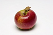 A red Lady apple with leaf