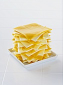 Slices of White and Orange American Cheese Piled High on a Dish
