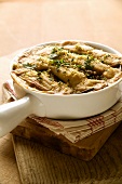 Baked Moussaka in a Casserole Dish on a Dish Cloth