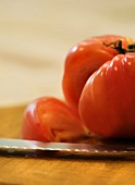 Close up of Tomato and Knife, Wedge Removed