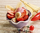 A Dish of Strawberries and Bananas Topped with Strawberry Yogurt