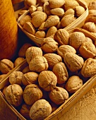 Walnuts and Almonds with Shells in Wooden Baskets