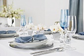 Place Settings with Blue Cloth Napkins on a Hanukkah Dining Table