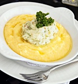 Bowl of Polenta Topped with Cod and Curly Parsley, Fork