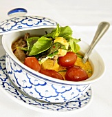 Bowl of Thai Roasted Duck in Red Curry Sauce with Tomatoes and Basil