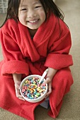 Young Girl Holding a Bowl of Fruit Flavored O Cereal