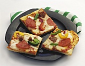 Square Pieces of Pepperoni, Sausage, Pepper and Onion Pizza