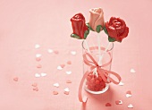 Three Chocolate Rose Pops on a Glass with Pink Candy and Ribbon