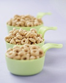 Toasted Oat Cereal in Three Green Measuring Cups
