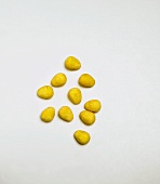 Yellow Egg-Shaped Candies on White Background