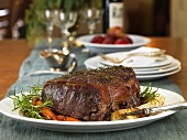 Herbed Roast Beef on a Platter with Fresh Rosemary and Vegetables