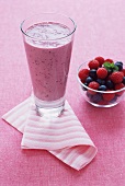 Berry Smoothie in a Tall Glass; Bowl of Fresh Berries
