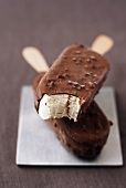 Two Chocolate Coated Ice Cream Bars; Stacked with Top Bar Bitten