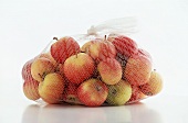 Crab Apples in Net Bag on a White Background