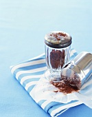 Cocoa Powder in Canister and Shaker with Some Spilled