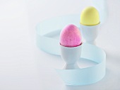 Pink and Yellow Easter Eggs in Egg Cups