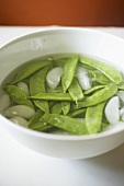 Organic Snow Peas in a Bowl of Ice Water