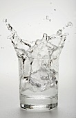Water Splashing in Glass on a White Background