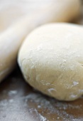 Ball of Pastry Dough with Rolling Pin on Floured Surface