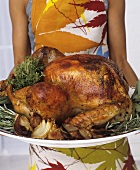 Woman serving roast turkey