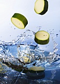 Courgette slices falling into water