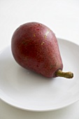 Organic Starkrimson Pear on a White Plate